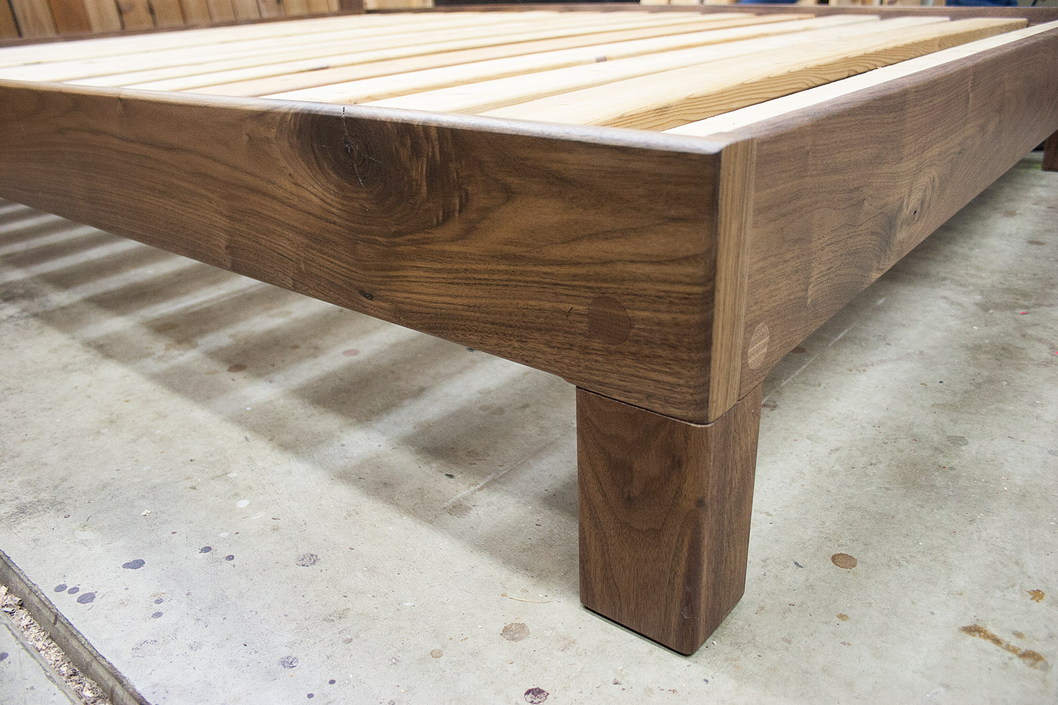 Live-edge walnut slab headboard frame corner